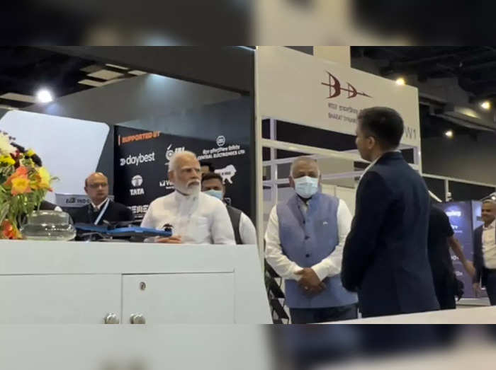 PM Modi interacts with a participant at Bharat Drone Mahotsav 2022 in Delhi on Friday.