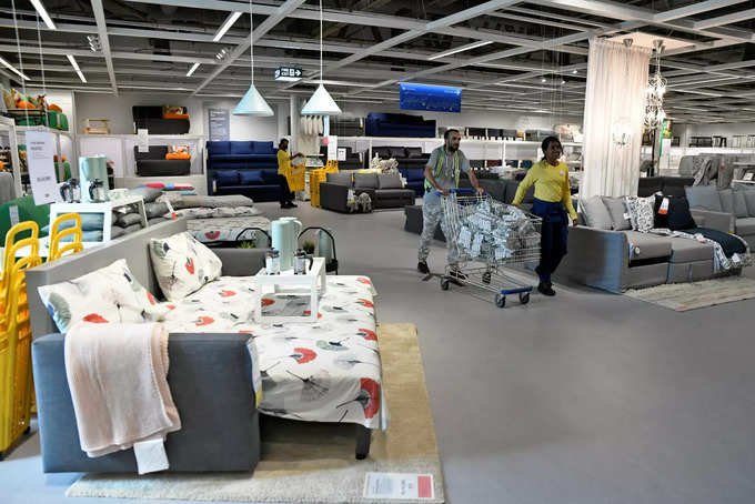 Employees push a cart inside IKEAs new store in Bengaluru