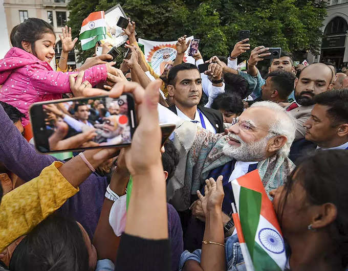 Munich_ Prime Minister Narendra Modi interacts with a child during his visit to ... (2).