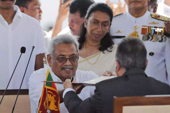 FILE - Then Sri Lanka&#39;s newly elected president Gotabaya Rajapaksa, center, hand....