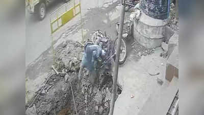 बाईक काढताना तोल गेला, तरुण खड्ड्यात पडला; पण नशीब बलवत्तर निघालं; पाहा VIDEO