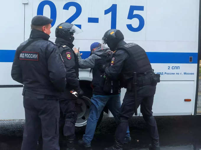 Russian police officers detain a person during a rally in Moscow (1).