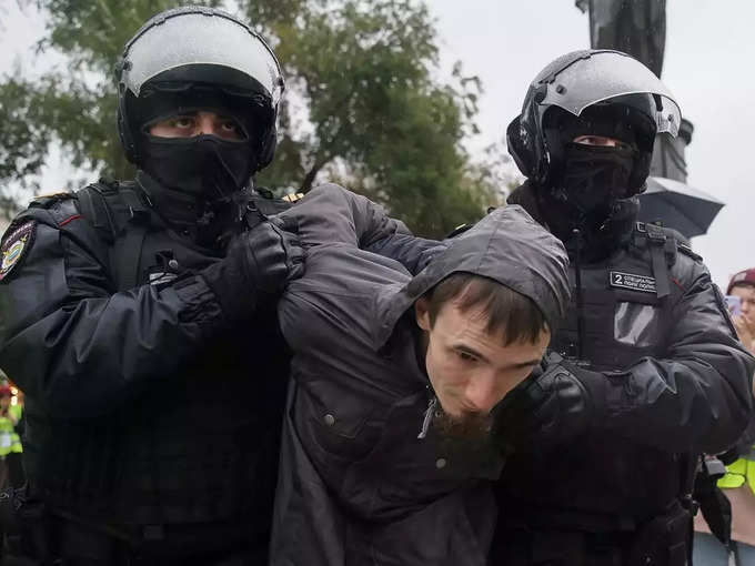 Russian police officers detain a person during a rally in Moscow.
