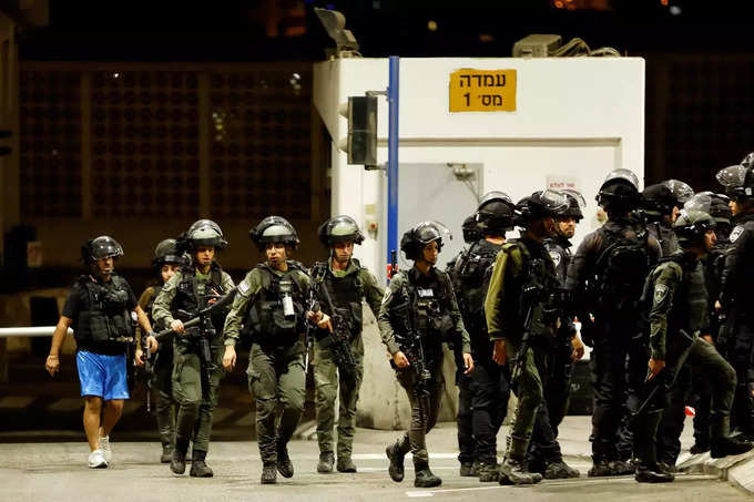 Israeli security forces are seen following a shooting incident at a check point in East Jerusalem, Israeli police said (1).