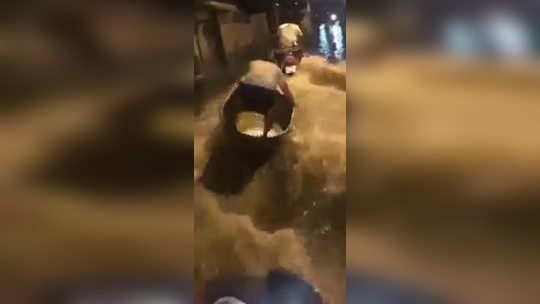 funny video of boy do water surfing on delhi road after heavy rain fall goes viral on social media