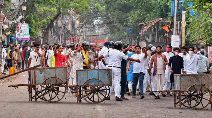 Howrah_ Security personnel cordon off an area after clashes broke out between tw....