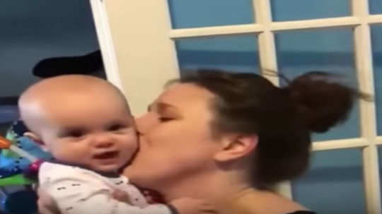 video of a baby covers mom in kisses is going viral