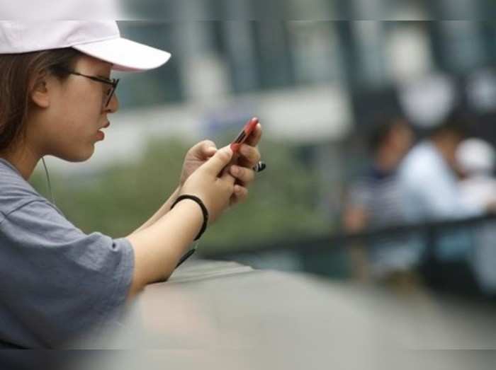 A woman uses a mobile phone in Beijing
