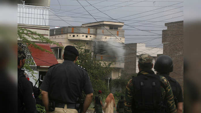 Pakistani security personnel look at a militant hideout during the crackdown operation in Peshawar, Pakistan, Tuesday, April 16, 2019. Pakistani authorities say a raid by security forces on a militant hideout in the northwestern city of Peshawar triggered a 15-hour shootout in which a police officer and many suspected militants were killed. (AP Photo/Muhammad Sajjad)