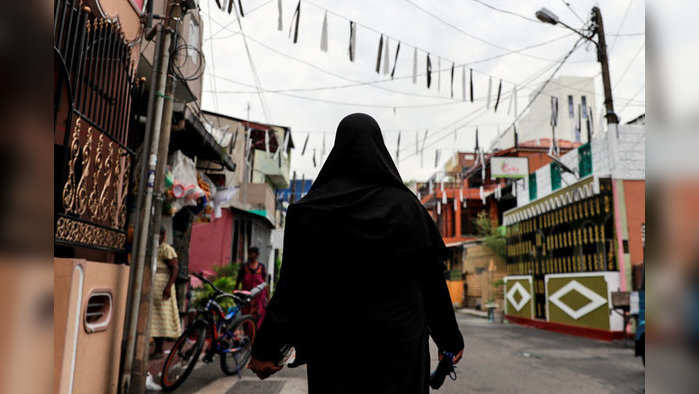 A Muslim woman wearing a hijab walks through a street near St Anthony's Shrine, days after a string of suicide bomb attacks across the island on Easter Sunday, in Colombo, Sri Lanka, April 29, 2019. REUTERS/Danish Siddiqui