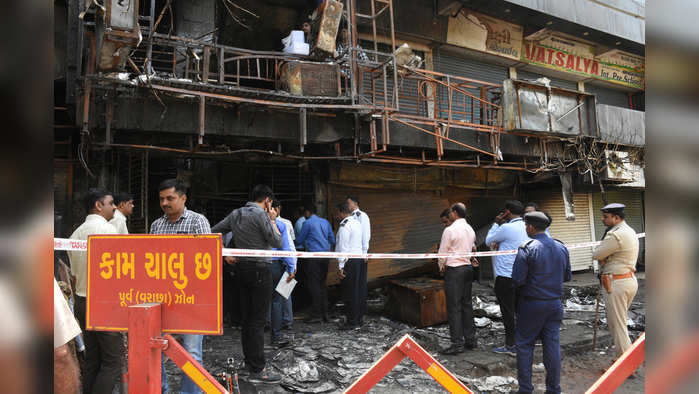 Gujrat, May 25(ANI): Principal Secretary (Urban Development and Urban Housing) Government of Gujarat, Mukesh Puri arrives for investigation at the coaching center building site where Massive fire kills 20 students in Surat on Saturday. (ANI Photo)