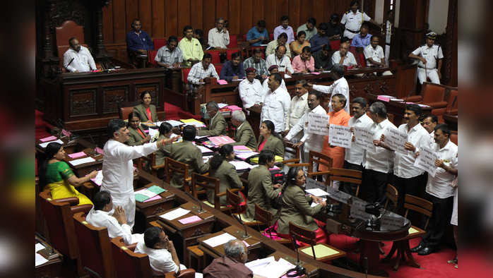 Karnataka, July 16 (ANI): Karnataka Minister DK Shivakumar argues with the protesting BJP MLCs, demanding for CM HD Kumarswamy resignation during the Council Session at Vidhan Soudha in Bengaluru on Tuesday. (ANI Photo)