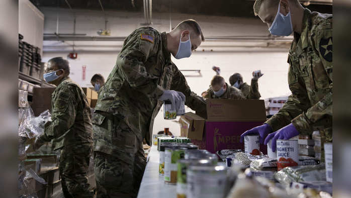 ??????? ???????? ??????? ???? ??????? ????? ????, ???????? ?????????? ?????? ???? ????? ??? ??? ????? ??????? ???? ??? ???????? ????? ???? ????.   Members of the Army and Air National Guard pack food boxes at the Nourish Pierce County food bank in Tacoma, Wash., on Friday, April 3, 2020. (Ruth Fremson/The New York Times)