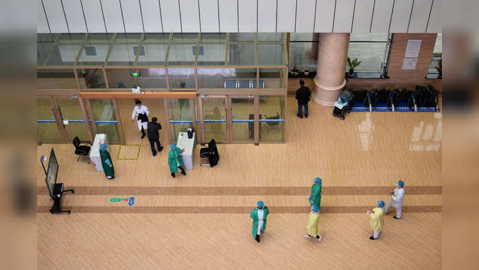 Medical workers are seen near the entrance at People's Hospital where asymptomatic patients are kept, following an outbreak of the coronavirus disease (COVID-19), in Suifenhe, a Chinese city bordering Russia, in Heilongjiang province, China April 14, 2020. REUTERS/Huizhong Wu