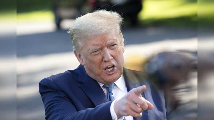 U.S. President Donald Trump speaks to members of the media on the South Lawn of the White House in Washington, D.C., U.S., on Friday, May 15, 2020. Trump's choice to lead the agency in charge of Voice of America is the subject of an investigation by the Washington, D.C. attorney general�s office, adding another hurdle to a nomination that's been stalled for two years. Photographer: Stefani Reynolds/CNP/Bloomberg