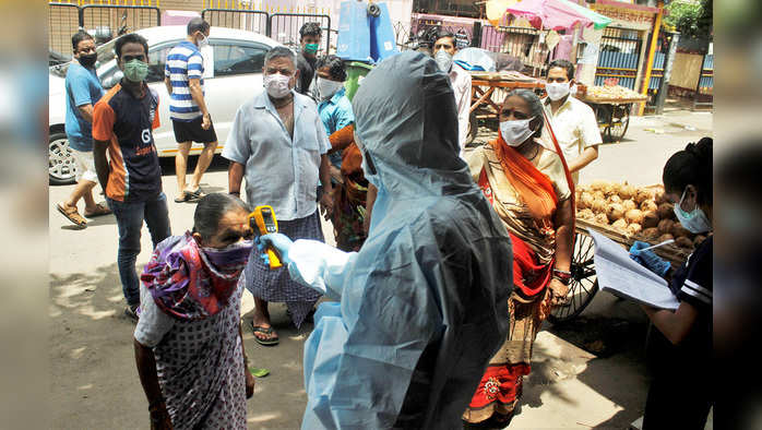 Maharashtra, June 21 (ANI): A health care worker checks the temperature of a resident at Dharavi, as a preventative measure against the spread of coronavirus disease, in Mumbai on Sunday. (ANI Photo)