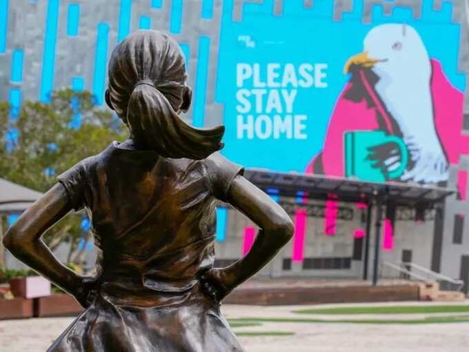 Fearless Girl statue looks at a.