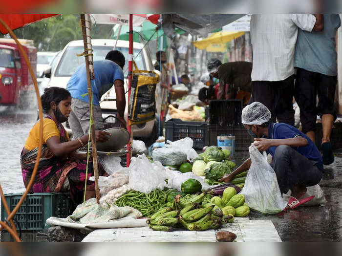Guwahati: Street vendors sell vegetables amid heavy rains in Guwahati. (PTI Pho...