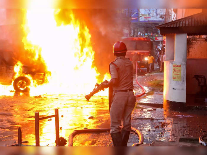 Agartala: A firefighter at the site after BJP workers allegedly put several vehi...