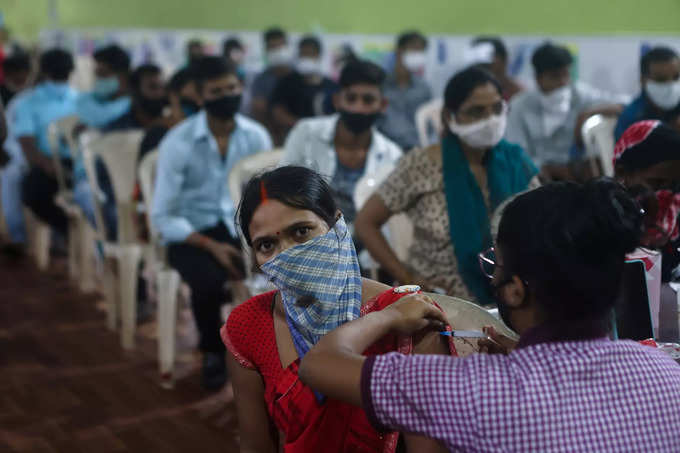 A woman receives a dose of AstraZenecas COVISHIELD vaccine during the COVID-19 vaccination campaign at a medical centre in Mumbai