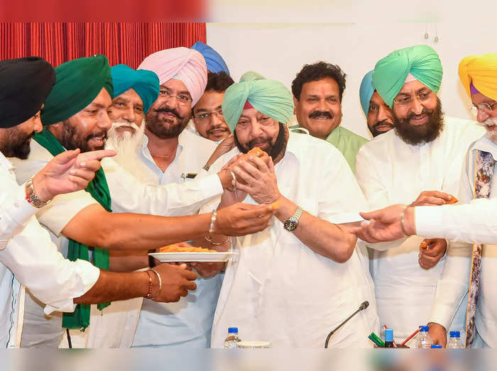 Chandigarh: Punjab Chief Minister Captain Amarinder Singh with sugarcane farmers...
