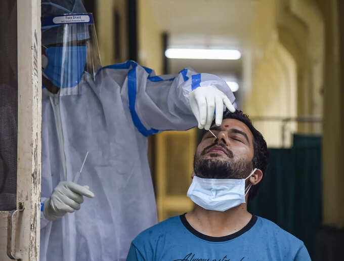 New Delhi: A medic collects swab sample of a person for COVID-19 tests, at Natio... New Delhi: A medic collects swab sample of a person for COVID-19 tests, at Natio...