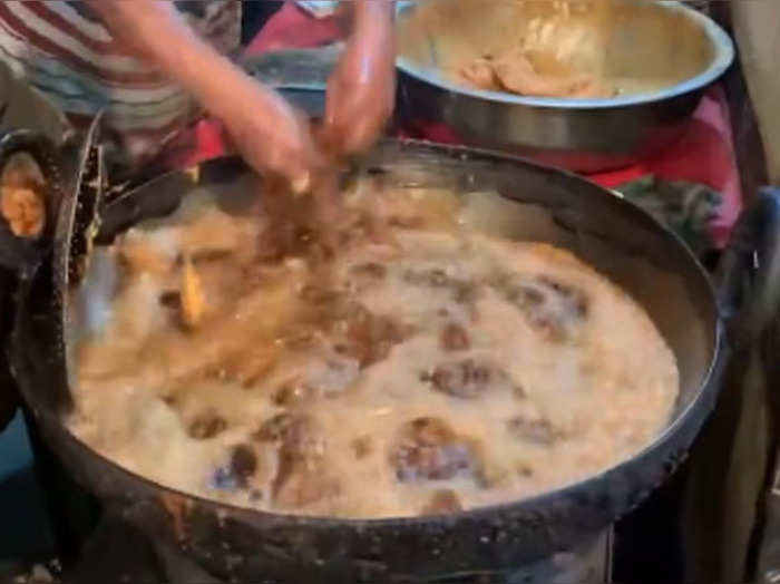 shocking video of street food vendor dips his hand in boiling hot oil while making fried chicken