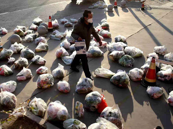 Worker prepares food supplies to be delivered to residents of a residential compound under lockdown in Xian.
