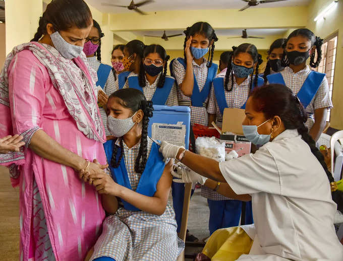 Hyderabad: School students receive COVID-19 vaccine dose, at a government school...