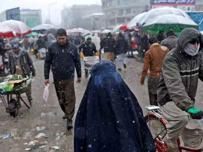FILE PHOTO_ An Afghan woman walks on the street during a snowfall in Kabul.