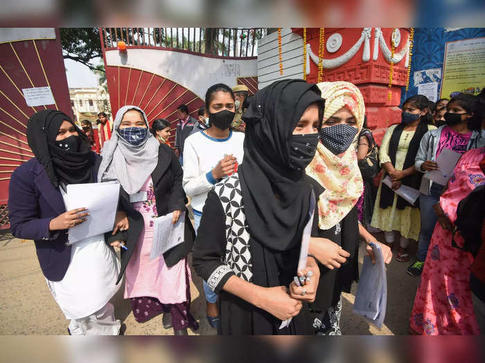 Patna: Students wearing burqa and hijab leave the examination centre, after appe...