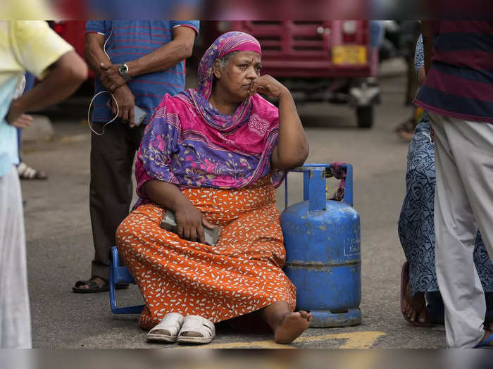 elderly woman sits outside a police station Sri Lanka