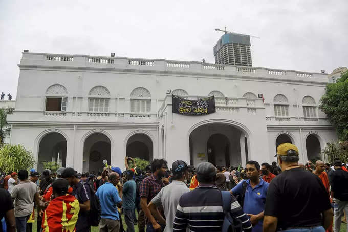 Sri Lankans storm presidents house, office in biggest rally.
