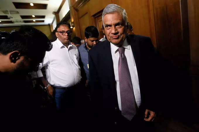 Sri Lankan Prime Minister Ranil Wickremesinghe leaves after a news conference in Colombo.