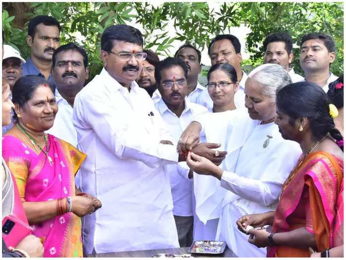 Women offering rakhis to the minister