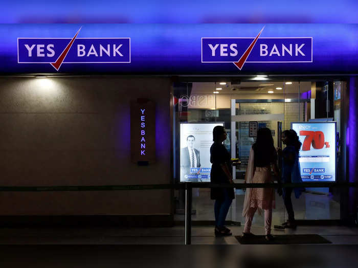 FILE PHOTO: Employees enter a Yes Bank branch at its headquarters in Mumbai